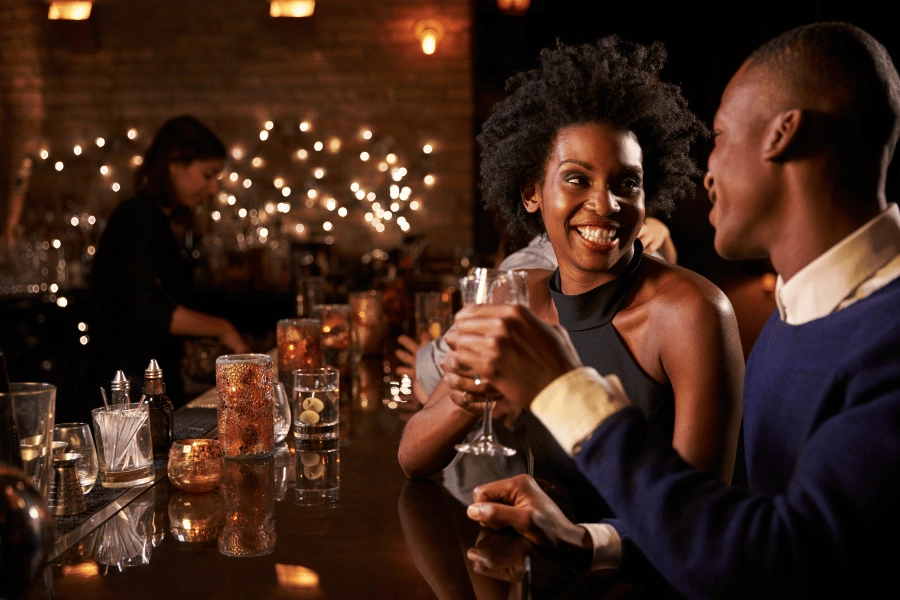 cute couple celebrating Valentine's Day dinner out at a tapas bar with drinks